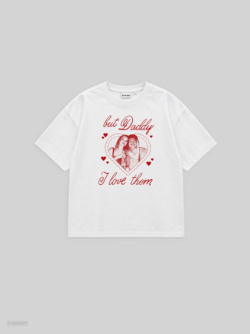 Weißes Oversized-T-Shirt in der Vorderansicht mit rotem Print: ein Foto von zwei Personen in einem Herzrahmen, umgeben von kleinen Herzen, darüber und darunter der Schriftzug „but Daddy I love them“ in Schreibschrift